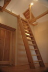 Wooden stairway to living attic-niche